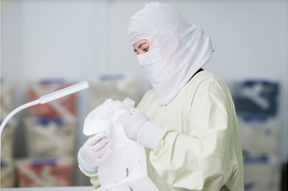 A worker inspects a remanufactured item.