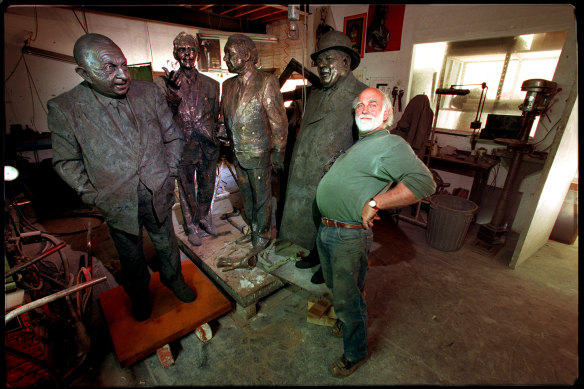 Peter Corlett with his statues of the 3000 club in November 1999.
