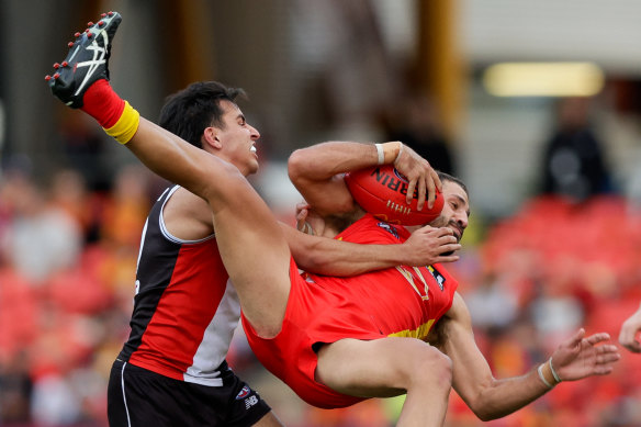 Topsy-turvy footy: Gold Coast’s Ben Long manages to mark.