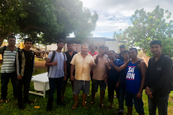 A group of the suspected asylum seekers with members of the Indigenous community where they first made contact.