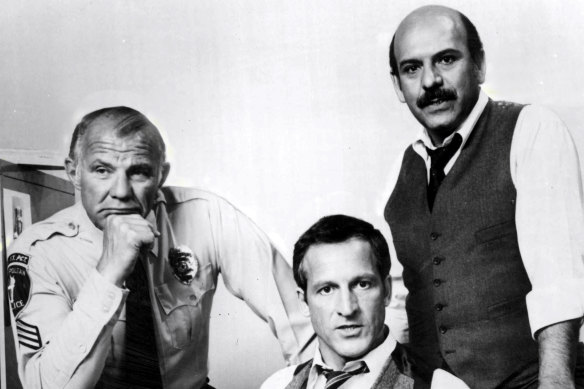 Michael Conrad as Sgt. Phillip Esterhaus, Daniel J. Travanti as Capt. Frank Furillo and Rene Enriquez as Lt. Roy Calletano in Hill Street Blues.