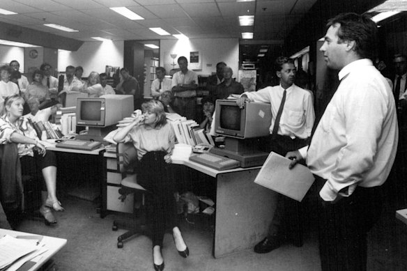Kohler talks to reporters in the AFR newsroom in 1988.