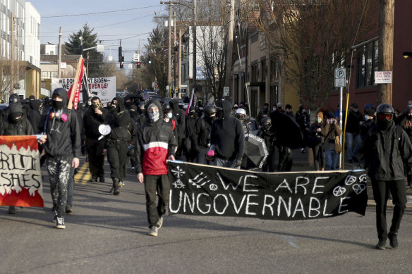 Demonstrators hold a sign saying “We are the ungovernable” during a protest march on Inauguration Day in Portland.