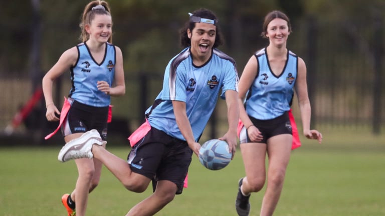 Juniors playing Oztag, a version of rugby league with velcro patches instead of tackling.