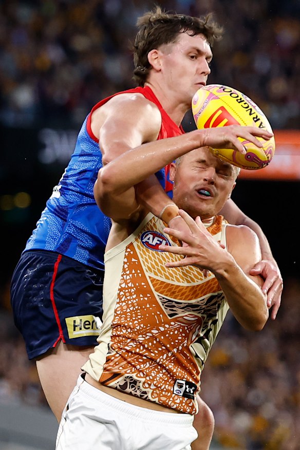 Demon Blake Howes looks to spoil Hawthorn’s Jack Ginnivan.