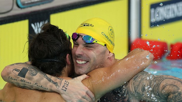 Ben Armbruster and Kyle Chalmers embrace after their gold medal-winning dead heat