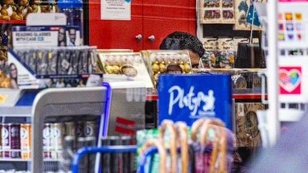 A tobacconist is seen peeking from a counter on Macquarie street, Sydney,