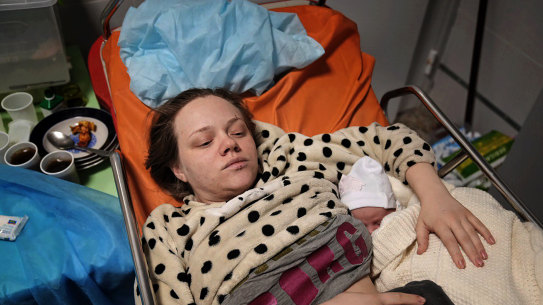Mariana Vishegirskaya cradles her daughter Veronika in a hospital bed after surviving the air strike on the maternity hospital. 