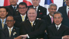 US Secretary of State Mike Pompeo, centre, crosses his arms for the traditional "ASEAN handshake" with Chinese Foreign Minister Wang Yi and other fellow diplomats during the ASEAN Regional Forum in Thailand in August.