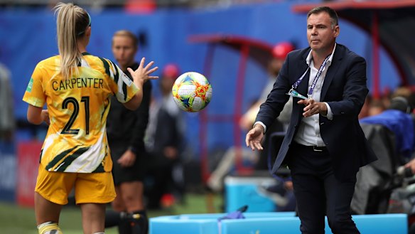 Matildas coach Ante Milicic passes the ball to Ellie Carpenter.