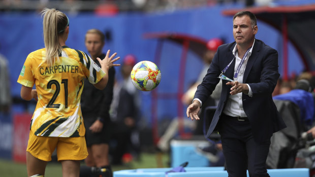Matildas coach Ante Milicic passes the ball to Ellie Carpenter.