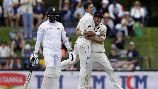 Boult is congratulated by teammate Neil Wagner after dismissing Lahiru Kumara on Thursday.