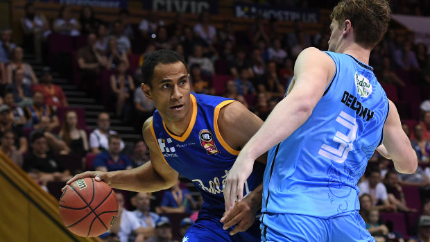 Mika Vukona of the Bullets (left) is blocked Finn Delany of the Breakers during the Round 5 NBL match at the Brisbane Convention and Entertainment Centre in Brisbane on Sunday.