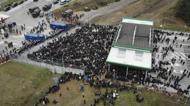 Migrants from the Middle East and elsewhere gather at the checkpoint “Kuznitsa” at the Belarus-Poland border near Grodno, Belarus.