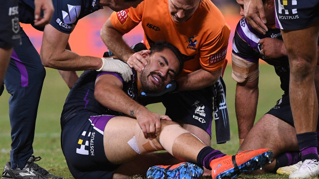 Down and out: Melbourne's Jahrome Hughes was injured after being taken high by Maika Sivo of the Eels.