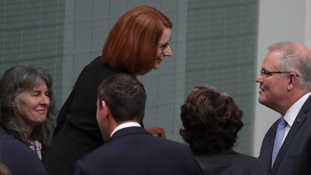 Prime Minister Scott Morrison greets former prime minister Julia Gillard, who established the commission.