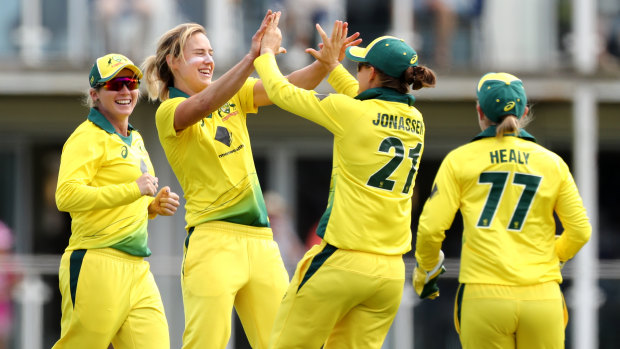 Devastating: Ellyse Perry (centre) claimed seven wickets against England.