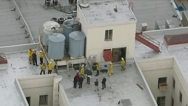 Firefighters and police officers on the Cecil Hotel roof in episode two of the series.