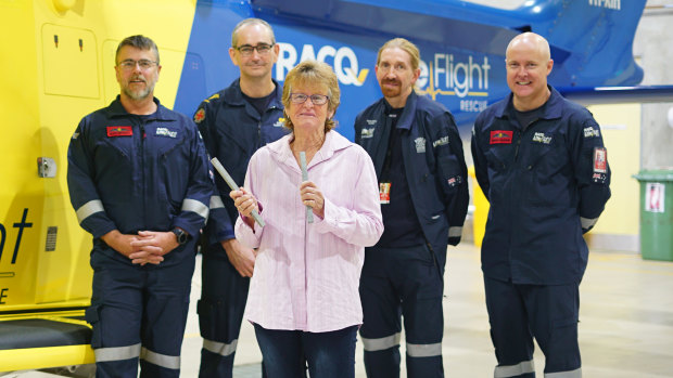 Ms Woolley with the helicopter crew which helped save her life that day.