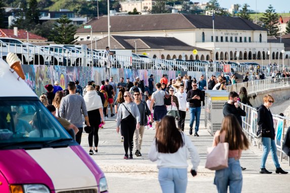 Crowds flocked to the grass and walkways at Bondi Beach on Sunday.