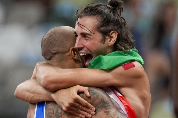 Tamberi embraces countryman Lamont Jacobs after the latter’s stirring 100m triumph in Tokyo.