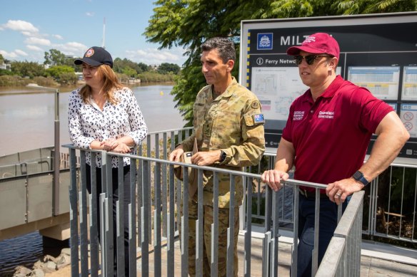 Premier Annastacia Palaszczuk, Major-General Jake Ellwood and Deputy Premier Steven Miles survey the Brisbane River in Milton. 