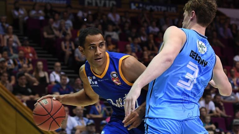 Mika Vukona of the Bullets (left) is blocked Finn Delany of the Breakers during the Round 5 NBL match at the Brisbane Convention and Entertainment Centre in Brisbane on Sunday.