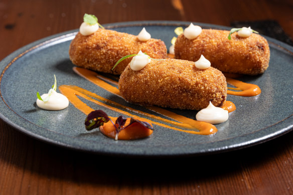 Potato and chorizo croquettes with romesco sauce.