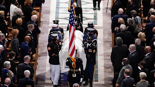 A military bearer team carries the casket after the funeral for former Secretary of State Colin Powell. 