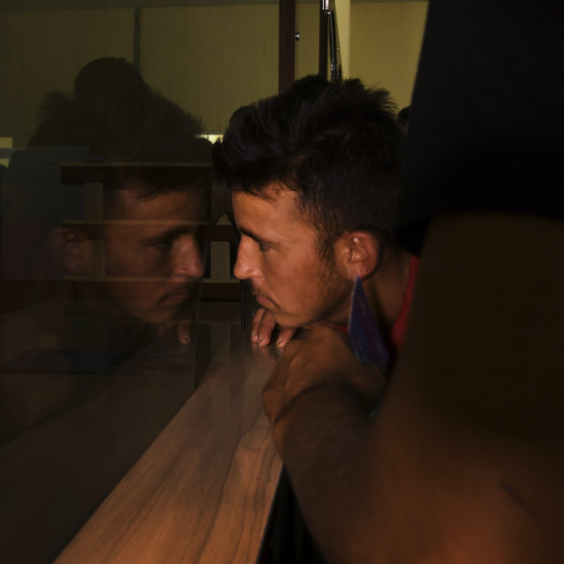 Unaccompanied minor Asdullah, 17, being processed by Afghan officials at Zero Point.