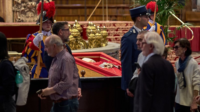 Inside St Peter’s, mourners weep for the pope they loved. Outside, speculation is already swirling
