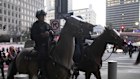 Los Angeles Police Department officers on horseback move through a street during a protest on Tuesday, June 10, 2025, in Los Angeles. 