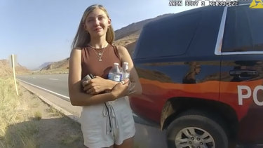 A still taken from a police camera video shows Gabrielle “Gabby” Petito talking to a police officer after the van she was travelling in with her boyfriend Brian Laundrie was pulled over near Arches National Park on August 12, 2021.
