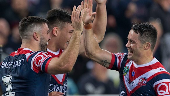 Mission accomplished: Cooper Cronk and James Tedesco celebrate after Joseph Manu's try.