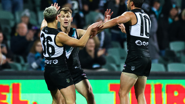 On target: Robbie Gray (centre) kicked two goals for Port Adelaide.