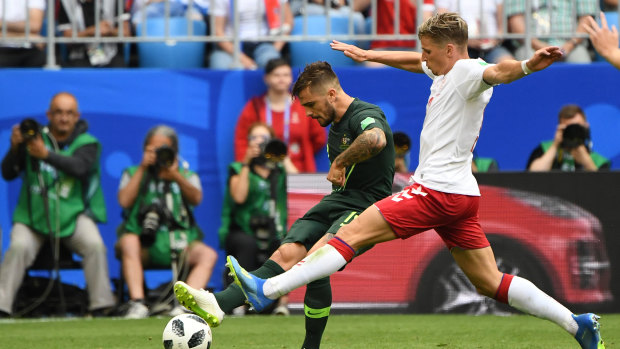 Big improver: Josh Risdon gets the ball away under pressure from Jens Stryger Larsen.