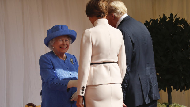 Queen Elizabeth II, left, smiles as she greets President Donald Trump and First Lady Melania Trump at Windsor Castle.