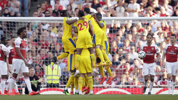 Palace's players celebrate after James McArthur scored his side's third goal to seal the win over Arsenal.