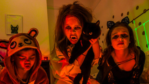 Tom and Eve Lyon, Frankie the cat and Scarlett Horskins getting ready for Halloween.