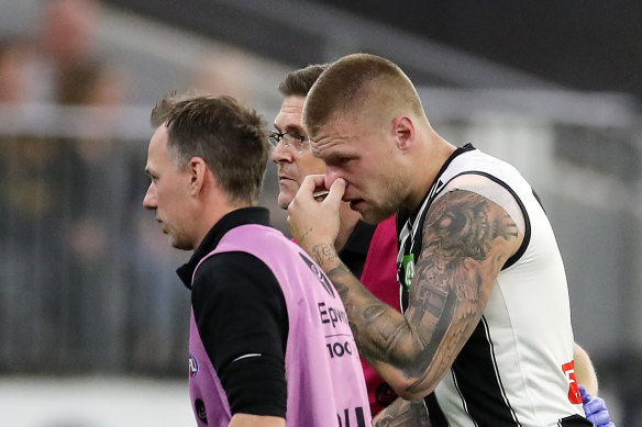 Jordan De Goey is helped off the ground.