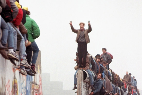 Berliners celebrate on top of the wall on Sunday, November 12, 1989.