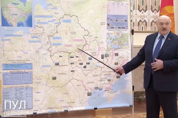 Belarus President Alexander Lukashenko points to a map of Ukraine appearing to show troop positions.