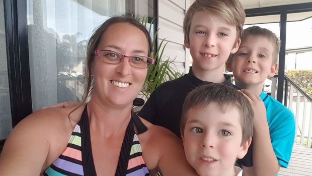 Kat Fisher with her children, five-year-old Dylan (front middle), seven-year-old Ashley (back right) and nine-year-old Jayden (back left).