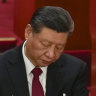 Chinese President Xi Jinping looks through documents during the opening session of the National People’s Congress.