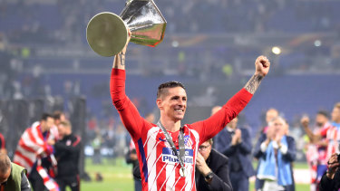 Superstar: Fernando Torres with the Europa League trophy in May.