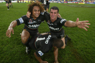 Scott Sattler (right) celebrates the 2003 grand final win with Panthers teammate Joe Galuvao.