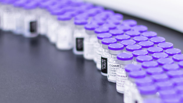 Vials of the Pfizer-BioNTech COVID-19 vaccine are prepared for packaging at the company’s facility in Puurs, Belgium.