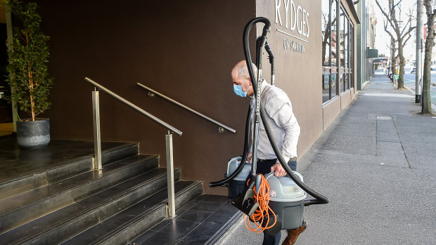 Leaked emails this week revealed patient zero was not a security guard but a night manager working at the Rydges Hotel in May. Pictured is a worker from a cleaning company.