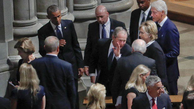 Former president George W. Bush, centre, leans in to talk to former vice-president Dick Cheney, as he walks out with, from left, former first lady Laura Bush, former president Barack Obama, former secretary of state Hillary Clinton and former president Bill Clinton, after attending the memorial service for Senator John McCain.