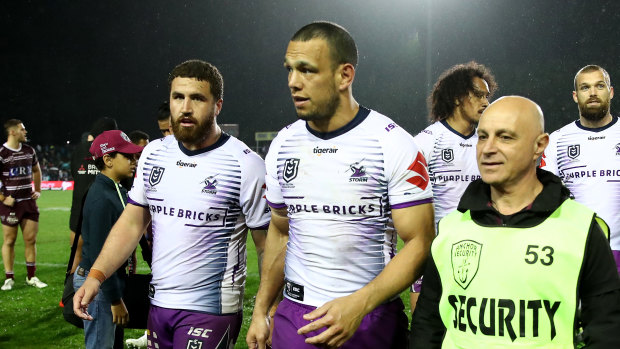 Security detail: Will Chambers is escorted from the field following the Manly-Storm match at Lottoland.
